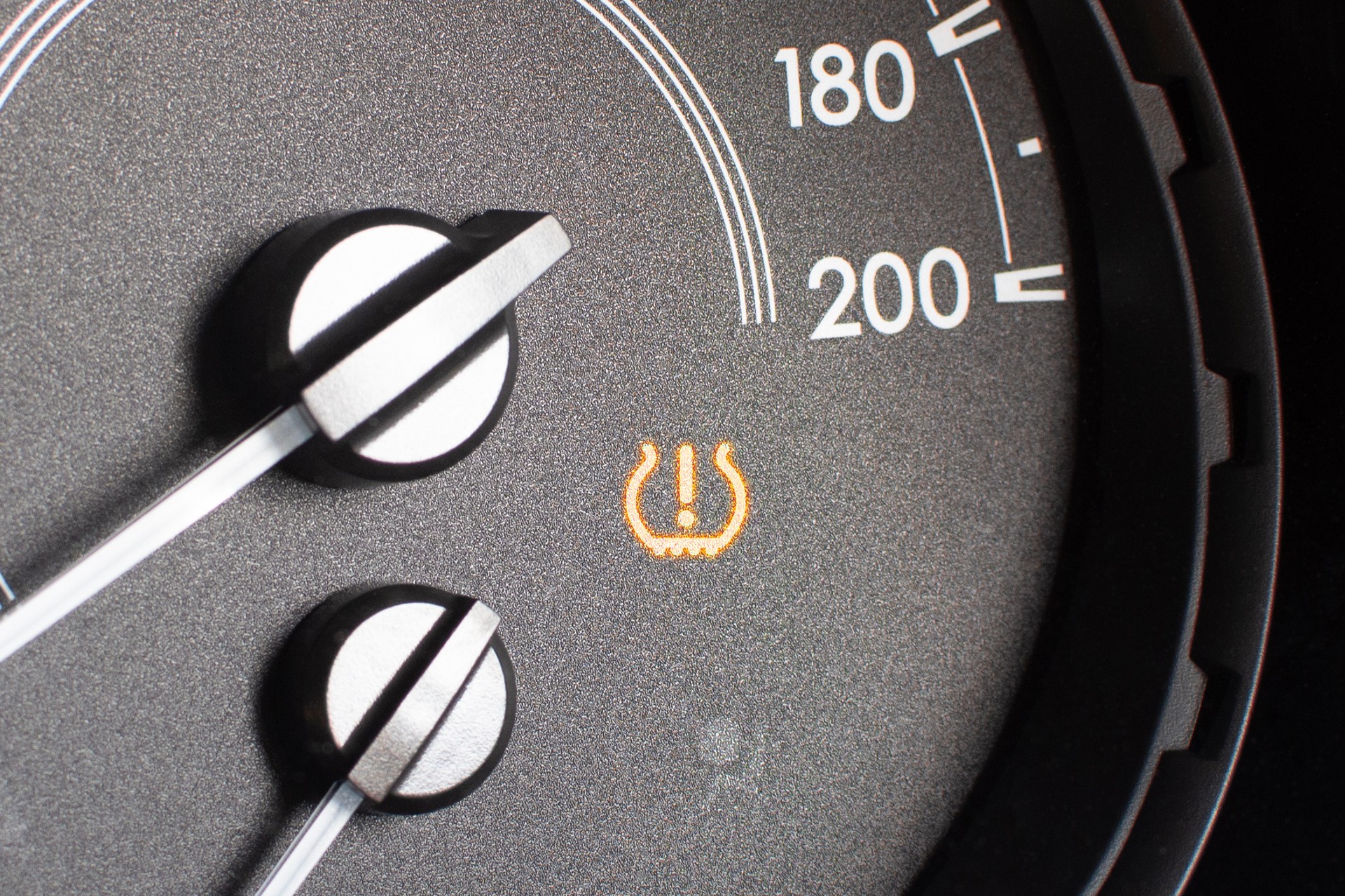 Tire pressure warning light on car dashboard